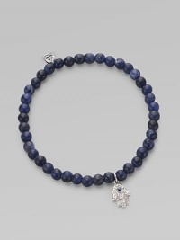 The hamsa, a traditional protective amulet, is encrusted with diamonds and accented with one sapphire as it hangs from a stretchy strand of deep-toned sodalite beads. Diamonds, 0.05 tcw Sodalite 14k white gold Diameter, about 2 (unstretched) Charm length, about ½ Imported The hamsa, a traditional protective amulet, is encrusted with diamonds and accented with one sapphire as it hangs from a stretchy strand of deep-toned sodalite beads. Diamonds, 0.05 tcw Sodalite 14k white gold Diameter, about 2 (unstretched) Charm length, about ½ Imported