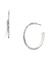 Polish your look with effortless sparkle. Nine West's three-quarter hoop earrings feature seamless sparkle in glass crystals. Crafted in silver tone mixed metal. Approximate diameter: 1-1/2 inches.