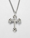 A traditional cross pendant rendered in fine sterling silver with a curb link chain necklace exudes timeless appeal.Sterling silverLength about 24Lobster claspMade in USA