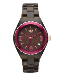 Time for dessert. Chocolate brown and candy pink are perfect on this Cambridge watch by adidas. Brown translucent plastic bracelet and round nylon case with gold tone and pink aluminum bezel. Brown grid-patterned dial features pink numerals at three, six and nine o'clock, stick indices, date window at four o'clock, three hands and logo. Quartz movement. Water resistant to 50 meters. Two-year limited warranty. Time for dessert. Chocolate brown and candy pink are perfect on this Cambridge watch by adidas. Brown translucent plastic bracelet and round nylon case with gold tone and pink aluminum bezel. Brown grid-patterned dial features pink numerals at three, six and nine o'clock, stick indices, date window at four o'clock, three hands and logo. Quartz movement. Water resistant to 50 meters. Two-year limited warranty.