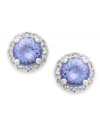 True beauties. These stunning earrings feature round-cut tanzanite (9/10 ct. t.w.) surrounded by halos of round-cut diamonds (1/8 ct. t.w.). Set in sterling silver. Approximate diameter: 7-1/2 mm.