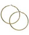 Shine like gold. These classic hoop earrings from GUESS showcase subtle texture for added style. Crafted in gold tone mixed metal. Approximate diameter: 2-1/2 inches.