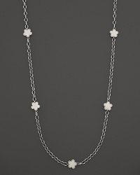 White mother-of-pearl floral stations punctuate this sterling silver link necklace from Lagos.