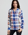 A weekend-wardrobe staple, Equipment's classic silk blouse takes on a vibrant plaid print for off-duty chic.