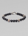 A bold statement in sterling silver and matte onyx with handsome engraved detail. Sterling silver Onyx 8mm beads About 9 long Imported 