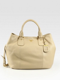 Top-handle carryall crafted from rich leather with metal logo detail.Double top handles, 5¼ dropAdjustable detachable shoulder strap, 17-17½ dropTop snap closureProtective metal feetOne inside zip pocketOne inside open pocketPrada logo lining14½W X 13½H X 6DMade in Italy Top-handle carryall crafted from rich leather with metal logo detail.Double top handles, 5¼ dropAdjustable detachable shoulder strap, 17-17½ dropTop snap closureProtective metal feetOne inside zip pocketOne inside open pocketPrada logo lining14½W X 13½H X 6DMade in Italy