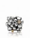 A cluster of sterling silver daisies with 14K gold and diamond centers. Charm by PANDORA.