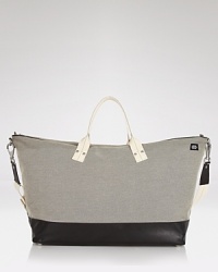 A handsome tote for all your essentials, designed in an understated color block style with a crossbody strap and handles for easy carrying. A handsome tote for all your essentials, designed in an understated color block style with a crossbody strap and handles for easy carrying.