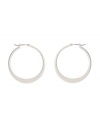Shimmery hoops with a modern spin. Kenneth Cole New York earrings feature a graduated hoop in silver tone mixed metal. Approximate diameter: 1-1/4 inches.