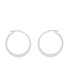 Shimmery hoops with a modern spin. Kenneth Cole New York earrings feature a graduated hoop in silver tone mixed metal. Approximate diameter: 1-1/4 inches.