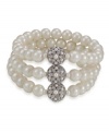 Add vintage glamour to an everyday look with this romantic bracelet by Carolee. Three rows of glass pearls secured by three medallions gleaming with crystal accents. Crafted in imitation rhodium-plated mixed metal. Stretches to fist wrist. Approximate diameter: 3-1/4 inches.