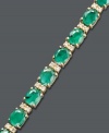 Enviable style. Effy Collection's stunning tennis bracelet features oval-cut emeralds (9-1/3 ct. t.w.) and round-cut diamonds (1/4 ct. t.w.). Set in 14k gold. Features a figure 8 safety clasp for secure wear. Approximate length: 7-1/2 inches. Approximate width: 1/8 inch.