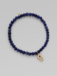 The open hand or hamsa, a symbol of protection to many cultures, is depicted in diamonds set in 14k yellow gold with a sapphire center, and hangs on a strand of deeply hued sodalite beads. Diamonds, 0.04 tcw Sapphire Sodalite 14k yellow gold Diameter, about 2 Charm length, about ½ Stretch cord Imported The open hand or hamsa, a symbol of protection to many cultures, is depicted in diamonds set in 14k yellow gold with a sapphire center, and hangs on a strand of deeply hued sodalite beads. Diamonds, 0.04 tcw Sapphire Sodalite 14k yellow gold Diameter, about 2 Charm length, about ½ Stretch cord Imported
