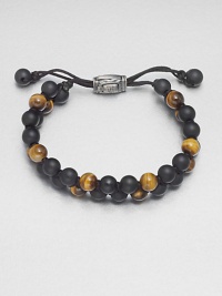 Smooth beaded bracelet of black onyx and tiger's eye with sterling silver lobster clasp.Black onyx/tigers eyeLobster claspAbout 2½ diam.Made in the United Kingdom Smooth beaded bracelet of black onyx and tiger's eye with sterling silver lobster clasp.Black onyx/tigers eyeLobster claspAbout 2½ diam.Made in the United Kingdom