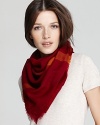 Wrap yourself in style with a sheer, woven wool scarf featuring Burberry's iconic check pattern in red and orange hues.