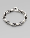 Alternating oval and thorn links in polished sterling silver. About 9½ long Lobster clasp Imported