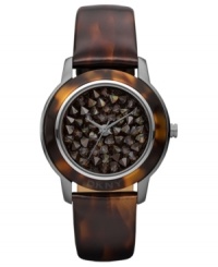 A modern watch design from DKNY with eye-catching neutral-hued stones at the dial. A modern watch design from DKNY with eye-catching neutral-hued stones at the dial.