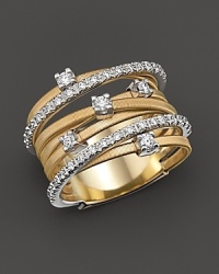 From the Goa collection, the banded ring with diamond accents on yellow and white gold, designed by Marco Bicego. From the Goa collection, the banded ring with diamond accents on yellow and white gold, designed by Marco Bicego.