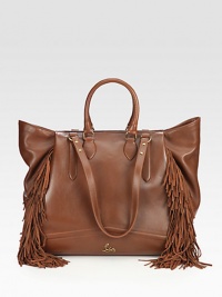 An artistic leather design with theatrical, suede fringe accents.Double top handles, 5 dropDouble shoulder straps, 10 dropTop zip closureProtective metal feetOne inside zip pocketOne inside open pocketSignature red lining16½W X 13H X 5DMade in Italy An artistic leather design with theatrical, suede fringe accents.Double top handles, 5 dropDouble shoulder straps, 10 dropTop zip closureProtective metal feetOne inside zip pocketOne inside open pocketSignature red lining16½W X 13H X 5DMade in Italy