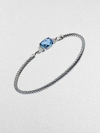 From the Petite Wheaton Collection. A faceted pillow of richly hued blue topaz, edged with diamonds and set on a classic sterling silver cable bangle.Diamonds, 0.08 tcwBlue topazSterling silverDiameter, about 2½3mm cableHook claspImported From the Petite Wheaton Collection. A faceted pillow of richly hued blue topaz, edged with diamonds and set on a classic sterling silver cable bangle.Diamonds, 0.08 tcwBlue topazSterling silverDiameter, about 2½3mm cableHook claspImported