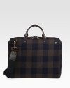 A lightly padded laptop case designed in rugged plaid-check wool with leather handles. Zip closure16L X 12H X 3DImported