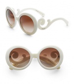 Sophisticated design in a round shape with lavish baroque accents. Available in blue with gradient blue lens, black with gradient gray lens, white with gradient brown lens, tortoise with gradient brown lens, tan with brown gradient lens or havana with purple gradient lens.Acetate frame with APX lens 100% UV protective Made in Italy