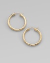 From the Martellato Collection. Graceful hoops with a rich hammered texture in gleaming 18k gold.18k yellow goldDiameter, about 1¼PiercedMade in Italy