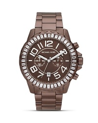 Make a sporty statement wit this cooly-hued watch from MICHAEL Michael Kors. Boating an oversized bezel and glitzy accents, it will add easy impact to every look. Make a sporty statement wit this cooly-hued watch from MICHAEL Michael Kors. Boating an oversized bezel and glitzy accents, it will add easy impact to every look.