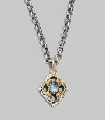 Chic little blossom accent in gleaming sterling silver and 18k gold, centered with a smooth cabochon blue topaz stone. Chain sold separately About ½W X ¾H Imported