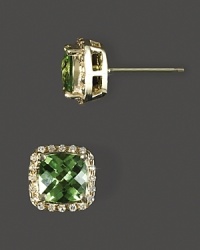 Diamonds frame faceted peridot, set in 14K yellow gold. Diamonds frame faceted peridot, set in 14K yellow gold.