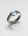 A colorful, square-edged band of channel-set sapphires creates a sweet surrounding for a faceted pastel blue topaz.Sapphires and blue topazBlack rhodium-plated sterling silverWidth, about .8Imported