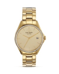 A crystal-encrusted bezel adds luxe sparkle to this gold-plated stainless steel watch from kate spade new york. A crystal-encrusted bezel adds luxe sparkle to this gold-plated stainless steel watch from kate spade new york.