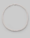 From the Akoya collection. A classic strand of white Akoya pearls with a pretty filigree clasp. 6.5mm white round cultured pearls Quality: A1 18k white gold Length, about 18 Mikimoto signature clasp Imported