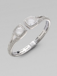 Two faceted doublets surrounded by dazzling stones on a stone encrusted bangle. Rhodium plated brassCrystalsCubic zirconiaCeramicDiameter, about 2¼ Hinged closureImported Two faceted doublets surrounded by dazzling stones on a stone encrusted bangle. Rhodium plated brassCrystalsCubic zirconiaCeramicDiameter, about 2¼ Hinged closureImported