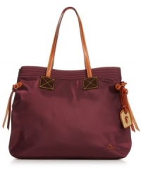 Laid-back with luxe appeal, this tailored tote from Dooney & Bourke is outfitted for everyday. Crafted in durable nylon with sturdy leather straps and signature hardware, it's spacious interior easily stows your work-to-weekend essentials. Laid-back with luxe appeal, this tailored tote from Dooney & Bourke is outfitted for everyday. Crafted in durable nylon with sturdy leather straps and signature hardware, it's spacious interior easily stows your work-to-weekend essentials.