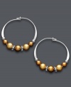 A tri-color blend spices up a traditional pair of hoop earrings. Jody Coyote's unique design offers a metallic mix of copper and gold Austrian crystal pearls threaded onto delicate, sterling silver hoops. Approximate diameter: 3/4 inch.