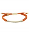 Set the tone for summer! Michael Kors' chic macrame bracelet features woven coral cotton cord with a gold tone mixed metal bar, accented with glistening pave glass stones. Clasp and logo charms crafted in gold tone mixed metal. Approximate diameter: 2 to 2-3/4 inches. Bracelet adjusts to fit wrist.