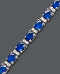 Stun them with sapphire. Effy Collection's head-turning tennis bracelet highlights oval-cut sapphires (12 ct. t.w.) and sparkling round-cut diamonds (1/4 ct. t.w.) set in 14k white gold. Features a figure 8 clasp for secure wear. Approximate length: 7-1/2 inches. Approximate width: 1/8 inch. Stun them with sapphire. Effy Collection's head-turning tennis bracelet highlights oval-cut sapphires (12 ct. t.w.) and sparkling round-cut diamonds (1/4 ct. t.w.) set in 14k white gold. Features a figure 8 clasp for secure wear. Approximate length: 7-1/2 inches. Approximate width: 1/8 inch.