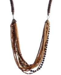 Create a subtle layered effect with earth tones. Brown, black and white glass and wooden beading make Haskell's trendy long necklace a neutral go-to that blends with any look. Set in brass-plated mixed metal. Approximate length: 33 inches. Create a subtle layered effect with earth tones. Brown, black and white glass and wooden beading make Haskell's trendy long necklace a neutral go-to that blends with any look. Set in brass-plated mixed metal. Approximate length: 33 inches.
