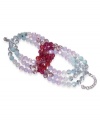 Pale pastels freshen up any ensemble. This sparkling beaded bracelet by Swarovski features mint and fuchsia crystal beads in an overlapping loop design. Crafted in silver tone mixed metal. Approximate length: 7 inches.