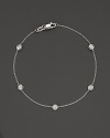 White gold bezel-set diamond cluster bracelet. With signature ruby accent. Designed by Roberto Coin.