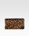 Plush leopard-print calf hair is paired with smooth leather trim in this versatile design. Detachable chain shoulder strap, 11½ dropTop zip closureOne inside open pocketSignature red lining11½W X 7H X 1DMade in Italy
