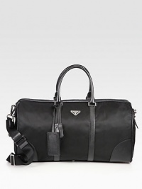 Tessuto nylon travel duffel with textured saffiano leather trim and logo detail.Zip closureDouble top handlesAdjustable shoulder strapInterior zip pocketIdentification tagNylon20W x 10H x 9DMade in Italy Tessuto nylon travel duffel with textured saffiano leather trim and logo detail.Zip closureDouble top handlesAdjustable shoulder strapInterior zip pocketIdentification tagNylon20W x 10H x 9DMade in Italy