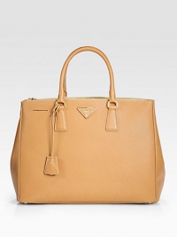 Rich calfskin leather finished with signature etching, all in a structured tote silhouette.Double top handles, 5 drop Zip and snap closure Protective metal feet One center zip compartment Two inside zip pockets Three inside open pockets Signature jacquard lining 14W X 10½H X 6D Made in Italy Rich calfskin leather finished with signature etching, all in a structured tote silhouette.Double top handles, 5 drop Zip and snap closure Protective metal feet One center zip compartment Two inside zip pockets Three inside open pockets Signature jacquard lining 14W X 10½H X 6D Made in Italy