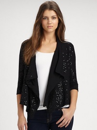The perfect cover-up in comfortable cotton and sparkling sequins with a fly-away, open front. Banded open necklineThree-quarter length sleevesDraped, open frontAsymmetrical hemSilk linedAbout 22 from shoulder to hem90% cotton/10% spandexHand washImported The perfect cover-up in comfortable cotton and sparkling sequins with a fly-away, open front. Banded open necklineThree-quarter length sleevesDraped, open frontAsymmetrical hemSilk linedAbout 22 from shoulder to hem90% cotton/10% spandexHand washImported