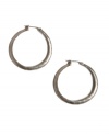 Every girl must own the perfect pair of hoops. Complementary to any ensemble, these Lucky Brand earrings feature a  small-sized hoop with a hammered surface in silver tone mixed metal. Approximate diameter: 1-3/4 inches.