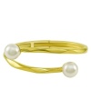 From the island of Mallorca, Spain, this beautiful hinged bangle bracelet features white organic man-made pearls (12 mm) set in 18k gold over sterling silver. Approximate diameter: 2-1/2 inches.