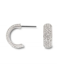 Covered in glittering pave crystals, Swarovski's huggie hoop earrings are a chic, classic look that's versatile enough to take you from the office to a night on the town! Set in silver tone mixed metal. Approximate diameter: 1/2 inch.