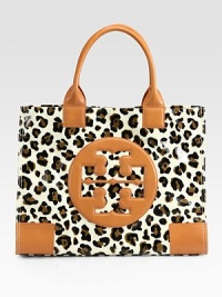 A signature logo is at the center of this coated leopard-print canvas design with warm leather trim. Double leather top handles, 7 dropMagnetic snap closureOne inside zip pocketTwo inside open pocketsCanvas lining17W X 13H X 5¾DImported A signature logo is at the center of this coated leopard-print canvas design with warm leather trim. Double leather top handles, 7 dropMagnetic snap closureOne inside zip pocketTwo inside open pocketsCanvas lining17W X 13H X 5¾DImported