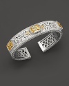 Sterling silver cuff set with faceted white sapphires and canary crystals. By Judith Ripka.